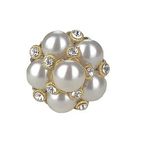 May include: A cluster of white pearls and clear rhinestones set in gold metal.