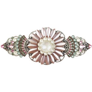 May include: A decorative hair barrette with a floral design. The barrette features a large, light pink flower with a pearl centre, surrounded by smaller pink, green, and pearl-coloured accents. The metalwork is silver-toned.