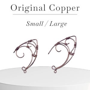May include: A pair of copper wire ear cuffs, one small and one large, in a delicate, intricate design.  Original Copper Small / Large.