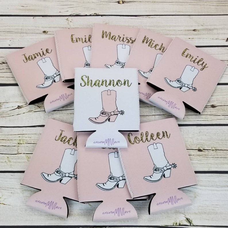 May include: Pink and white can coolers with personalized names and a gold glitter design of a cowboy boot. The names on the coolers are Jamie, Emil, Marissa, Mich, Emily, Shannon, Jack, and Colleen.