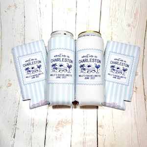 May include: Four white and blue striped can coolers and two beverage cans. The coolers and cans have the text "Meet me in Charleston" with a beach-themed graphic and "Molly's Bachelorette June 2027".