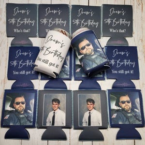 May include: Navy blue and white can coolers with the text "Drew's 50th Birthday" and photos. Some coolers have the phrases "Who's that?" and "You still got it!" printed on them. The image features a variety of designs.