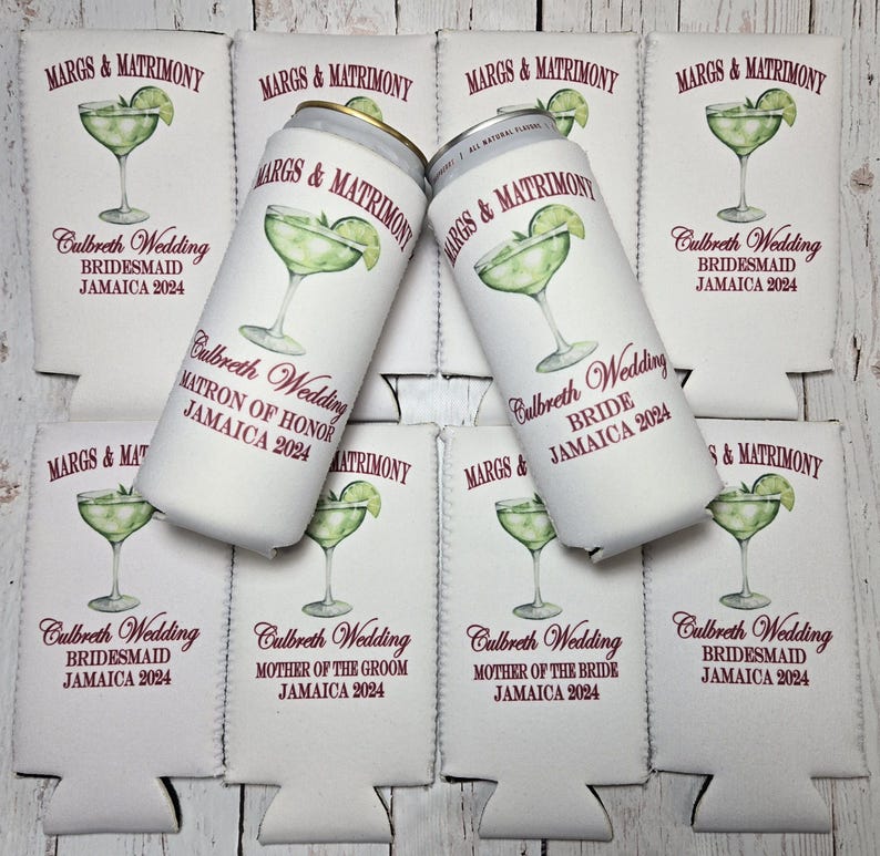 May include: White can coolers and beverage cans with a margarita design. The text on the coolers and cans reads "MARGS & MATRIMONY" and "Culbreth Wedding JAMAICA 2024" with various wedding party roles.