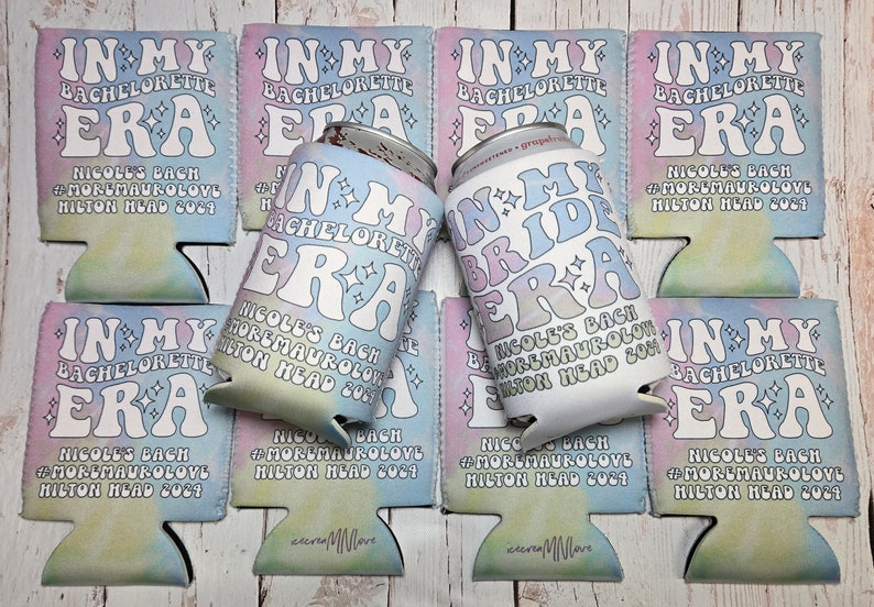 May include: A set of six colorful can coolers with the text "In My Era" and "In My Bride Era" in a retro font. The coolers are decorated with a tie-dye pattern and stars. The text "Nicole's Bach #MoreMauroLove Hilton Head 2024" is printed on each cooler.
