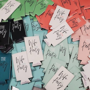 May include: A pile of colorful can coolers with the text "Wife of the Party" and "The Party" printed on them.