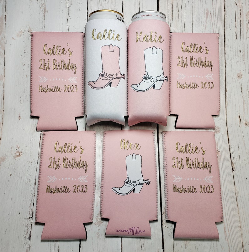 May include: Six pink and white can coolers with gold glitter text. The coolers feature a cowboy boot design and the text "Callie's 21st Birthday Nashville 2023". The names "Callie", "Katie", "Alex" are also included on the coolers.