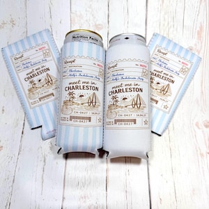 May include: Two can coolers and two matching koozies. The coolers and koozies are light blue with white stripes. The text "meet me in CHARLESTON" is printed on the coolers and koozies, along with a graphic of a bridge and palm trees.