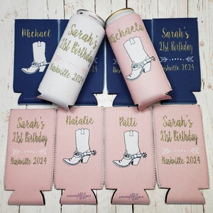 May include: Six pink and white can coolers with a gold glitter design. The coolers feature a cowboy boot design and the text "Sarah's 21st Birthday" and "Nashville 2024".