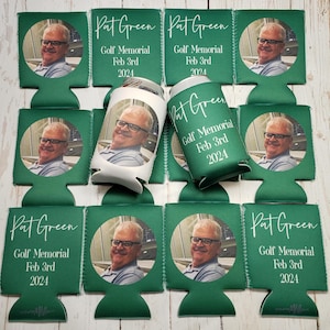 May include: A collection of green can coolers and a can featuring a photo of a man wearing glasses. The text "Pat Green Golf Memorial Feb 3rd 2024" is printed on the coolers in white script. The coolers are designed to keep beverages cold.
