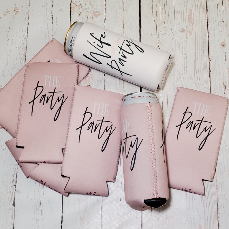 May include: Six pink and white can coolers with the text "The Party" printed on them. One white can cooler with the text "Wife of the Party" printed on it.
