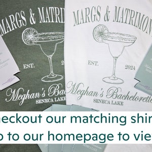 May include: Two t-shirts, one green and one white, with a margarita design and the text "MARGS & MATRIMONY" and "Meghan's Bachelorette SENECA LAKE". Matching can coolers are also visible. The image includes the text "Checkout our matching shirts! Go to our homepage to view!"