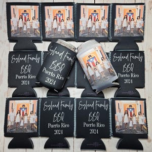 May include: Black can coolers and matching koozies with a family photo and text. The text reads "England Family BBQ Puerto Rico 2024". The koozies have a black background with white text and a photo of a family.