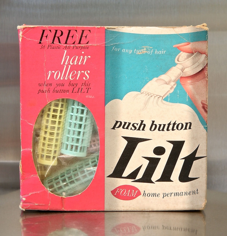 May include: A pink and blue box with the words 'FREE 36 Plastic All Purpose hair rollers' and 'push button Lilt FOAM home permanent' printed on it. The box includes a set of plastic hair rollers and a picture of a woman using a hair setting product.