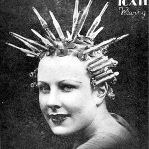 May include: A black and white photo of a woman with her hair in curlers. The curlers are made of metal and have a long, thin shape. The woman is looking at the camera with a smile. The text 'ICAII Waving' is visible in the upper right corner of the image.