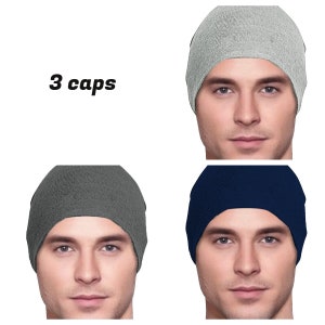 May include: Three plain knit beanies in gray, dark gray, and navy blue. The beanies are shown on three different models.