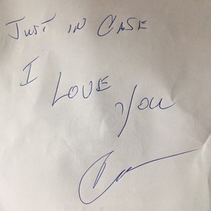 May include: A handwritten note on white paper that says "Just in case I love you" with a signature at the bottom.