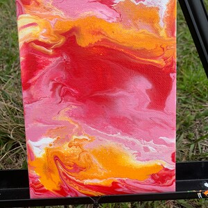 May include: Abstract painting on canvas with swirling patterns in shades of red, orange, yellow, and white.