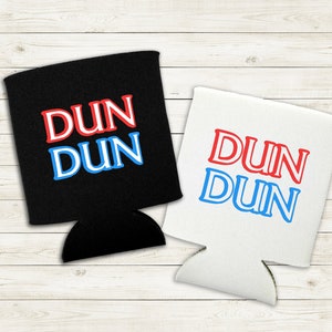 May include: Two black and white can coolers with the text "DUN DUN" in red and blue lettering.