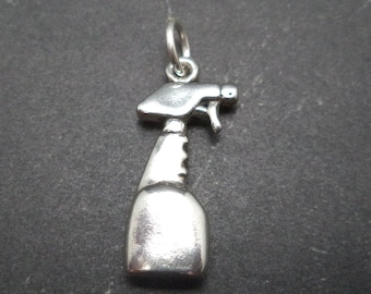 May include: Silver charm in the shape of a spray bottle. The charm is a simple design with a rounded bottle and a nozzle with a trigger.