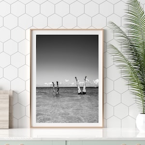 Framed Lifestyle Photography. Legs photo featuring two sets of legs in the air with a clear sky behind them. Weird wall art to spark conversation.