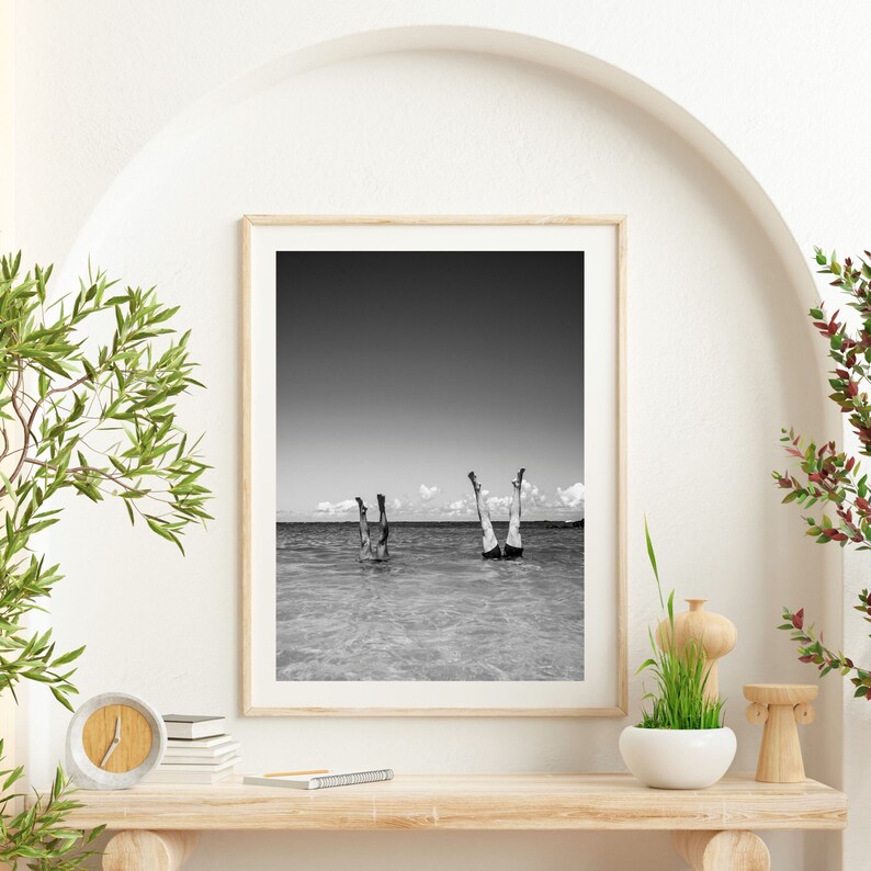 Black & White Ocean Lifestyle Photography Beach House Home Decor. Photo is of two legs in the air with bodies underwater in the ocean.
