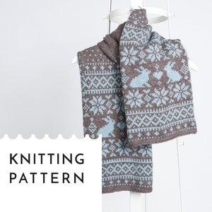May include: Knitting pattern for a brown and blue scarf with a snowflake and bunny design. The text "KNITTING PATTERN" is on a white background.