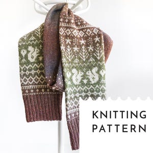 May include: A knitted scarf with a fair isle pattern, featuring squirrels and geometric designs in shades of brown, green, and white. The scarf is hanging on a white hanger. The text "KNITTING PATTERN" is visible.