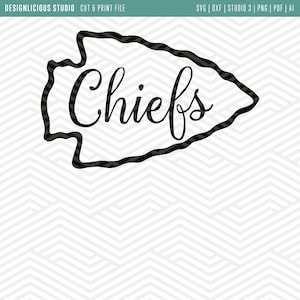 May include: Black and white graphic of the word "Chiefs" inside an arrowhead shape. The arrowhead has a striped border. The background has a white and gray chevron pattern. Text at the top reads "DESIGNLICIOUS STUDIO CUT & PRINT FILE".