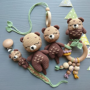 Otter themed baby gift set. Crochet toys bundle: pacifier clip, rattle, stuffed animal, hanging toy. Gender-neutral first birthday gift