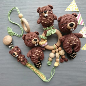 Beaver-themed baby gift set. Crochet toys bundle: pacifier clip, rattle, stuffed animal, hanging toy. Gender-neutral first birthday gift