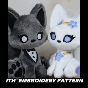 May include: A grey and white plush fox couple wearing a tuxedo and a wedding dress. The fox on the left is wearing a black bow tie and the fox on the right is wearing a gold necklace with a blue flower. The foxes are sitting next to each other and looking at the camera. "ITH EMBROIDERY PATTERN" is written in white letters on a black background at the bottom of the image.