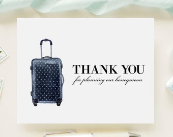 May include: A white card with black text that says "THANK YOU for planning our honeymoon." A black and white polka dot suitcase is illustrated on the left side of the card.