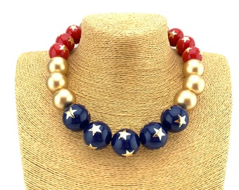 Blue and red vintage lucite with gold stars and gold wood necklace