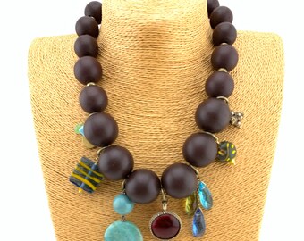 Chocolate brown graduated wood necklace with charms dangling between-stones, crystals, vintage charms