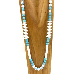 White ceramic teal-splattered beads with lots of vintage beads in long necklace