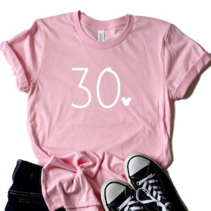 May include: Pink t-shirt with the number 30 and a small Mickey Mouse icon printed in white.