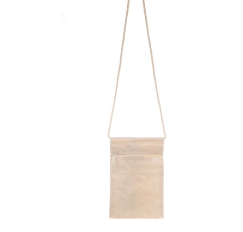 May include: A beige canvas crossbody bag with a zipper closure and a long adjustable strap.