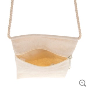 May include: A white canvas crossbody bag with a zipper closure and a rope strap.