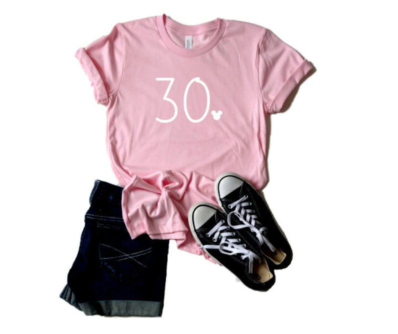 May include: Pink t-shirt with the number 30 and a small Mickey Mouse icon printed in white.