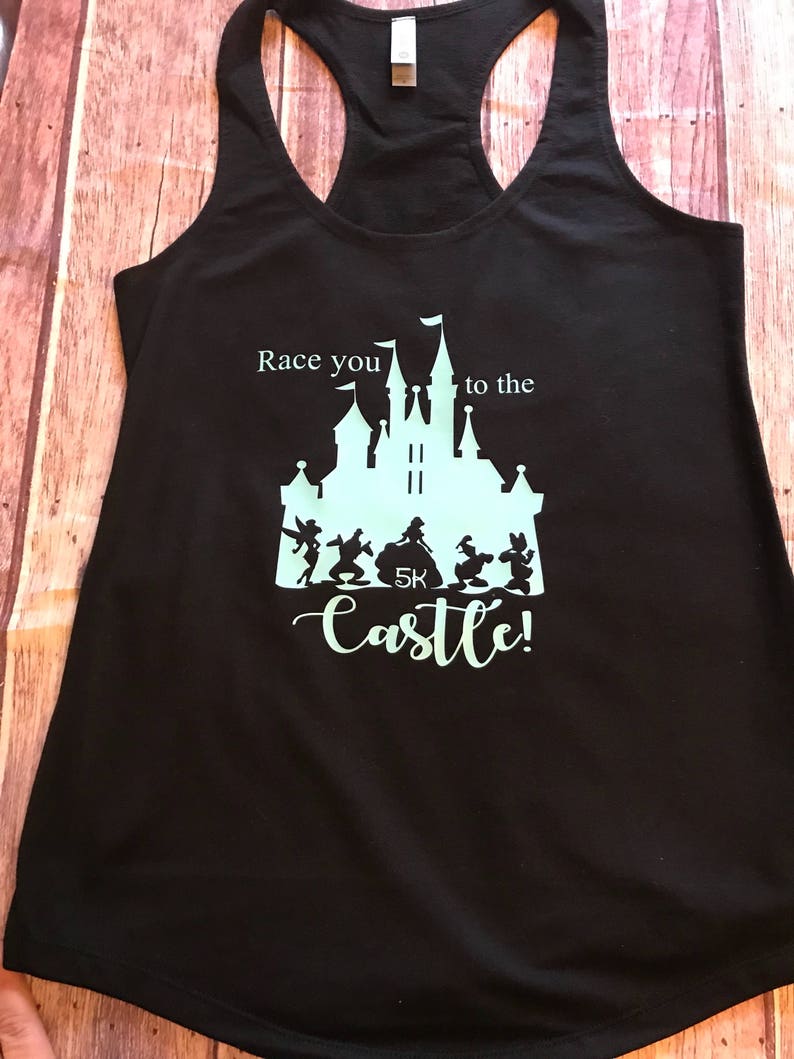 May include: Black tank top with a light blue graphic of Cinderella's castle and the text "Race you to the castle!" with a 5K logo.