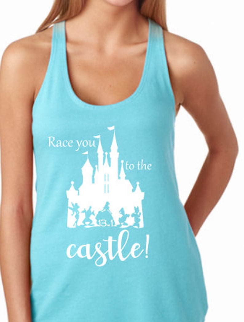 May include: A turquoise blue racerback tank top with a white graphic of a castle and the text "Race you to the castle!"