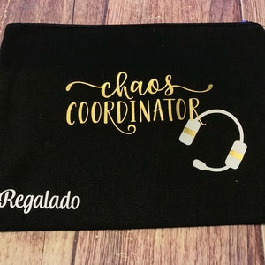 May include: Black canvas zippered pouch with gold lettering that reads "chaos coordinator" and a white headset graphic. The word "Regalado" is printed in white at the bottom.