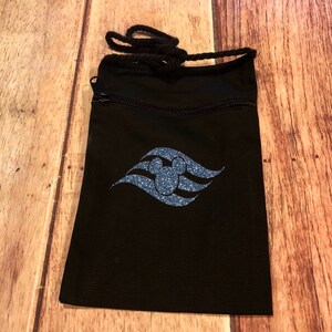 May include: Black drawstring bag with a zipper closure. The bag features a blue glitter Mickey Mouse head inside a blue glitter wave design.
