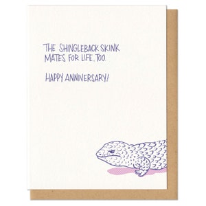May include: A greeting card with a purple illustration of a shingleback skink. The card reads "The shingleback skink mates for life, too. Happy Anniversary!"