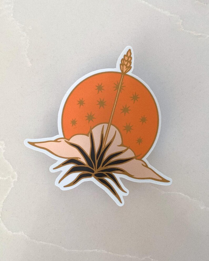 May include: A sticker featuring a stylized illustration of a plant with a single stalk rising from the center, set against a background of an orange sun with gold stars. The plant is depicted with a dark green stem and leaves, and the sun has a soft, peachy orange hue.