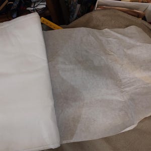 May include: A set of three ceramic mugs with a speckled, matte finish. The mugs are in shades of cream, light gray, and dark gray. Each mug has a simple, minimalist design, perfect for coffee or tea.