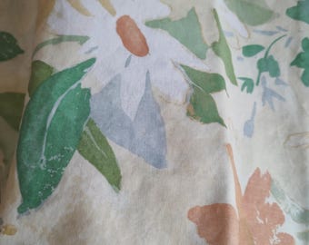 Pretty pastel fabric of florals, Daisies Yellow, Green, Orange, Blue. It may be prewashed. 53w x 1-3/4 yd long.