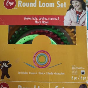 May include: A yellow box set for round loom knitting, featuring the "Boye" brand. The box includes the text "Round Loom Set" and "Makes hats, booties, scarves & Much More!" The set includes 4 looms, 1 hook, 1 needle, and instructions.