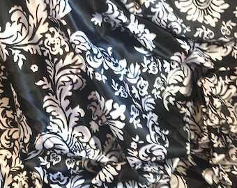 Nice feel of this faux silk charmeuse in a Damask design. 2 yds x 58" w. Slinky for skirt or blouse.Silver on Black