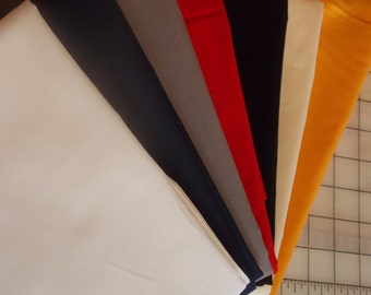 May include: A collection of fabric swatches in various colors, including white, navy blue, gray, red, cream, and yellow. The swatches are arranged in a fan shape, with the white swatch at the bottom and the yellow swatch at the top.